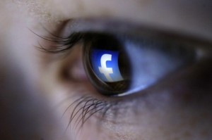 A picture illustration shows a Facebook logo reflected in a person's eye, in Zenica, March 13, 2015. Facebook Inc recorded a slight increase in government requests for account data in the second half of 2014, according to its Global Government Requests Report, which includes information about content removal.Requests for account data increased to 35,051 in the second half of 2014 from 34,946 in the first half, with requests from countries such as India rising and those from others including United States and Germany falling, the report by the world's largest Internet social network showed. Facebook said it restricted 9,707 pieces of content for violating local laws, 11 percent more than in the first half, with access restricted to 5,832 pieces in India and 3,624 in Turkey. Picture taken on March 13. REUTERS/Dado Ruvic (BOSNIA AND HERZEGOVINA - Tags: SOCIETY PORTRAIT SCIENCE TECHNOLOGY BUSINESS TELECOMS TPX IMAGES OF THE DAY)